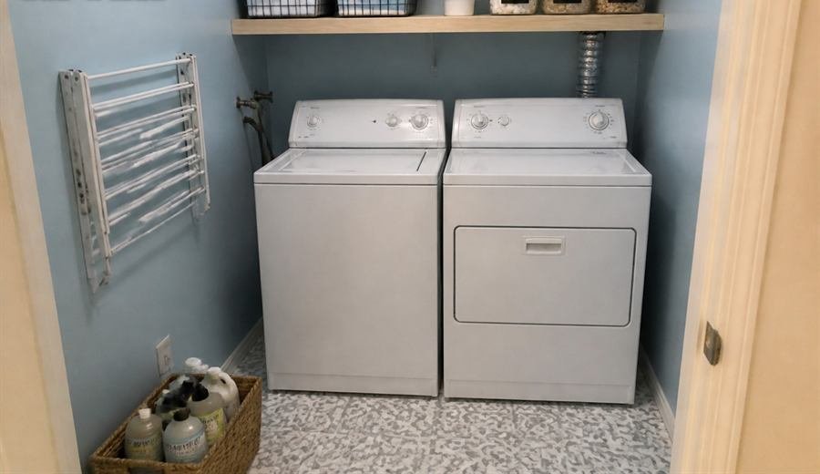 A renovated laundry room with open shelving, storage baskets and new patterned floor tile.